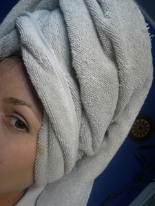 Cover ears and a good portion of forehead with towel to collect any dripping.